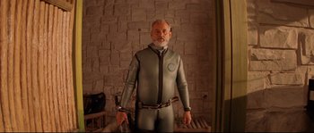 Movie still from “The Life Aquatic with Steve Zissou” (2004), directed by Wes Anderson – An older man in a silver suit with a gun strapped to his back; Medium shot, Low angle