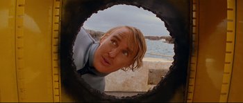 Movie still from “The Life Aquatic with Steve Zissou” (2004), directed by Wes Anderson – A person looking through a porthole; Close Up shot, Low angle