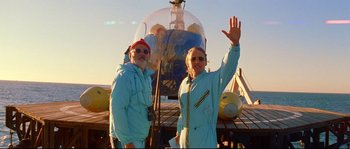 Movie still from “The Life Aquatic with Steve Zissou” (2004), directed by Wes Anderson – A man and a woman standing in front of an airplane; Wide shot, Low angle