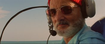 Movie still from “The Life Aquatic with Steve Zissou” (2004), directed by Wes Anderson – An older man with a beard wearing a headset; Close Up shot, Low angle