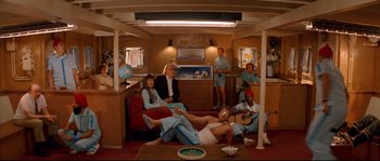 Movie still from “The Life Aquatic with Steve Zissou” (2004), directed by Wes Anderson – A group of people sitting and standing on top of a boat; Wide shot, High angle