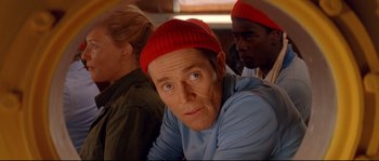 Movie still from “The Life Aquatic with Steve Zissou” (2004), directed by Wes Anderson – A group of people wearing hats and looking at the camera; Close Up shot, Over the shoulder angle