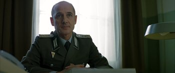 Movie still from “The Lives of Others” (2006), directed by Florian Henckel von Donnersmarck – A person wearing a uniform; Close Up shot, Low angle