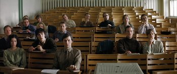 Movie still from “The Lives of Others” (2006), directed by Florian Henckel von Donnersmarck – A group of people sitting in a lecture hall; Medium shot, High angle