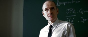 Movie still from “The Lives of Others” (2006), directed by Florian Henckel von Donnersmarck – A man wearing a white shirt and a black tie; Close Up shot, Low angle