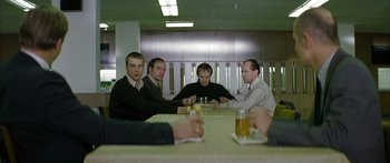 Movie still from “The Lives of Others” (2006), directed by Florian Henckel von Donnersmarck – A group of men sitting at a table with drinks; Medium shot, High angle