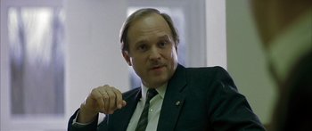 Movie still from “The Lives of Others” (2006), directed by Florian Henckel von Donnersmarck – A person wearing a suit and tie; Close Up shot, Low angle