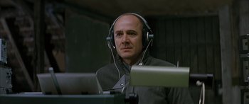 Movie still from “The Lives of Others” (2006), directed by Florian Henckel von Donnersmarck – A man wearing headphones and looking into the distance; Close Up shot, Low angle
