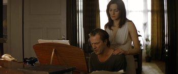 Movie still from “The Lives of Others” (2006), directed by Florian Henckel von Donnersmarck – A man and a woman sitting in front of a computer; Medium shot, Low angle