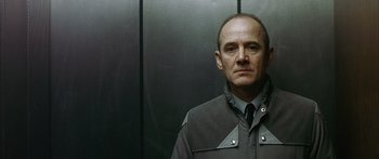 Movie still from “The Lives of Others” (2006), directed by Florian Henckel von Donnersmarck – A man standing in front of an elevator; Close Up shot, Low angle