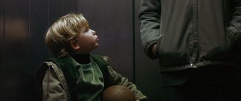 Movie still from “The Lives of Others” (2006), directed by Florian Henckel von Donnersmarck – A little boy sitting next to an older man holding a soccer ball; Close Up shot, Over the shoulder angle