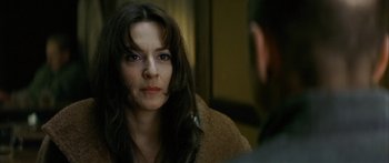 Movie still from “The Lives of Others” (2006), directed by Florian Henckel von Donnersmarck – A woman sitting in front of a mirror looking at a man; Close Up shot, Over the shoulder angle