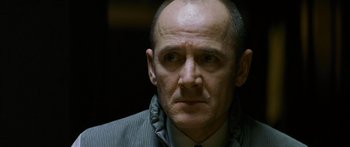 Movie still from “The Lives of Others” (2006), directed by Florian Henckel von Donnersmarck – A person wearing a suit and tie; Close Up shot, Low angle