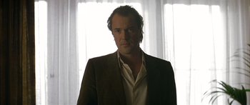 Movie still from “The Lives of Others” (2006), directed by Florian Henckel von Donnersmarck – A person wearing a suit and tie; Close Up shot, Low angle