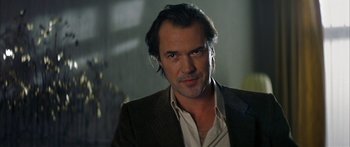 Movie still from “The Lives of Others” (2006), directed by Florian Henckel von Donnersmarck – A person wearing a suit and tie; Close Up shot, Low angle