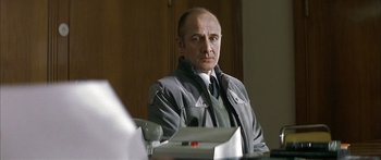 Movie still from “The Lives of Others” (2006), directed by Florian Henckel von Donnersmarck – A man sitting at a table in front of a computer; Close Up shot, Over the shoulder angle