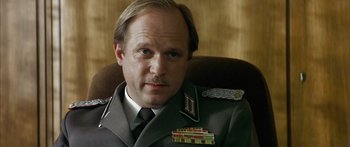 Movie still from “The Lives of Others” (2006), directed by Florian Henckel von Donnersmarck – A person wearing a uniform; Close Up shot, Low angle