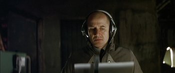Movie still from “The Lives of Others” (2006), directed by Florian Henckel von Donnersmarck – A man wearing headphones looking at a computer screen; Close Up shot, Low angle