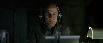 Movie still from “The Lives of Others” (2006), directed by Florian Henckel von Donnersmarck – A man wearing headphones looking at a computer screen; Close Up shot, High angle