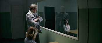 Movie still from “The Lives of Others” (2006), directed by Florian Henckel von Donnersmarck – A man and a woman looking in a mirror; Medium shot, Over the shoulder angle