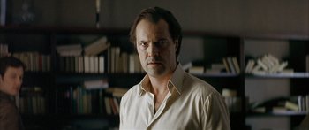 Movie still from “The Lives of Others” (2006), directed by Florian Henckel von Donnersmarck – A person wearing a white shirt; Close Up shot, Low angle