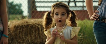 Movie still from “Real Steel” (2011), directed by Shawn Levy – A little girl holding a necklace in her hands; Close Up shot, Over the shoulder angle