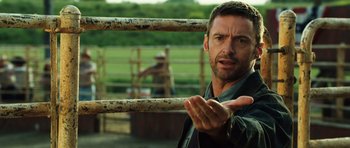 Movie still from “Real Steel” (2011), directed by Shawn Levy – A person behind a fence; Close Up shot, Over the shoulder angle
