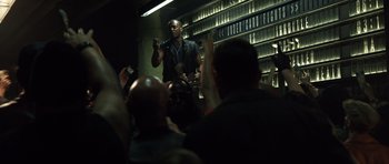 Movie still from “Real Steel” (2011), directed by Shawn Levy – A man standing in front of a group of people; Medium shot, Low angle