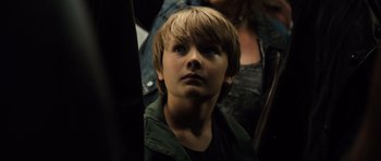 Movie still from “Real Steel” (2011), directed by Shawn Levy – A young boy is looking up at the sky; Close Up shot, High angle