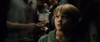 Movie still from “Real Steel” (2011), directed by Shawn Levy – A young boy is looking up at the sky; Close Up shot, Low angle
