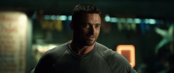Movie still from “Real Steel” (2011), directed by Shawn Levy – A person wearing a gray t - shirt; Close Up shot, Over the shoulder angle