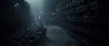 Movie still from “Real Steel” (2011), directed by Shawn Levy – A person walking in a dark room in the rain; Extreme Wide shot, High angle