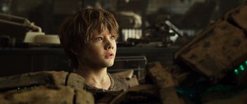 Movie still from “Real Steel” (2011), directed by Shawn Levy – A young boy with blue eyes is looking up; Close Up shot, Low angle