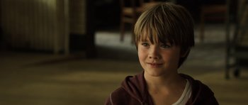 Movie still from “Real Steel” (2011), directed by Shawn Levy – A young boy is smiling for the camera; Close Up shot, Over the shoulder angle