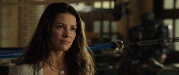Movie still from “Real Steel” (2011), directed by Shawn Levy – A beautiful woman with long brown hair holding a baseball bat; Close Up shot, Over the shoulder angle