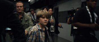 Movie still from “Real Steel” (2011), directed by Shawn Levy – A group of young people walking down a hallway; Medium shot, Low angle