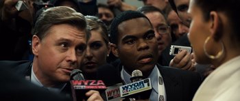 Movie still from “Real Steel” (2011), directed by Shawn Levy – A group of people with microphones in a room; Close Up shot, Over the shoulder angle