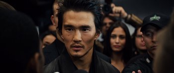 Movie still from “Real Steel” (2011), directed by Shawn Levy – A person with a crowd in the background; Close Up shot, Over the shoulder angle