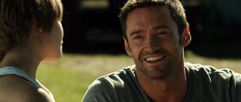 Movie still from “Real Steel” (2011), directed by Shawn Levy – A person with a smile on their face; Close Up shot, Over the shoulder angle