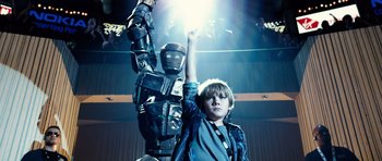 Movie still from “Real Steel” (2011), directed by Shawn Levy – A young boy standing in front of a large robot; Medium shot, Low angle
