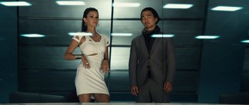 Movie still from “Real Steel” (2011), directed by Shawn Levy – A man and a woman standing next to each other in front of a building; Medium shot, Low angle