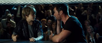 Movie still from “Real Steel” (2011), directed by Shawn Levy – A man talking to a young boy in front of an audience; Medium shot, Over the shoulder angle