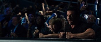 Movie still from “Real Steel” (2011), directed by Shawn Levy – A man and a boy are watching a concert; Medium shot, Low angle