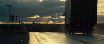 Movie still from “Real Steel” (2011), directed by Shawn Levy – A truck driving down a road near a forest; Extreme Wide shot, Low angle