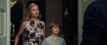 Movie still from “Real Steel” (2011), directed by Shawn Levy – A woman standing next to a young boy in front of a door; Medium shot, Low angle