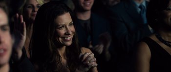 Movie still from “Real Steel” (2011), directed by Shawn Levy – A woman smiling and clapping her hands in front of a crowd; Close Up shot, High angle