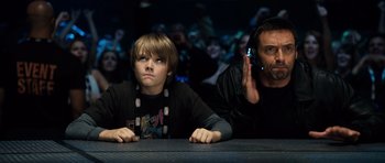 Movie still from “Real Steel” (2011), directed by Shawn Levy – A man and a boy sitting next to each other at a table; Close Up shot, Over the shoulder angle