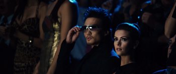Movie still from “Real Steel” (2011), directed by Shawn Levy – A man and a woman wearing sunglasses in a crowd of people; Medium shot, Over the shoulder angle