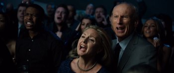Movie still from “Real Steel” (2011), directed by Shawn Levy – A group of people that are in a room together; Medium shot, Low angle