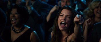 Movie still from “Real Steel” (2011), directed by Shawn Levy – A woman with her mouth wide open in a crowd of people; Close Up shot, Low angle